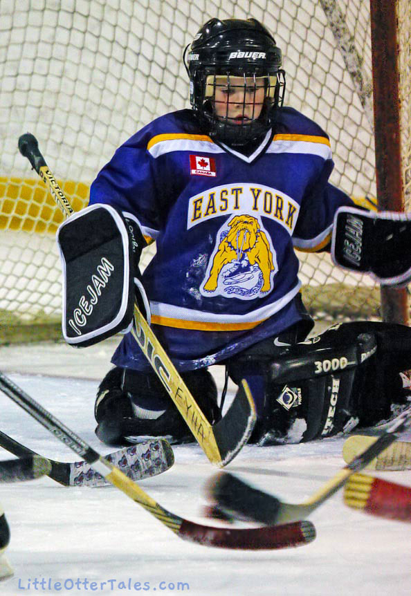 hockey game action - little goalie boy under attack