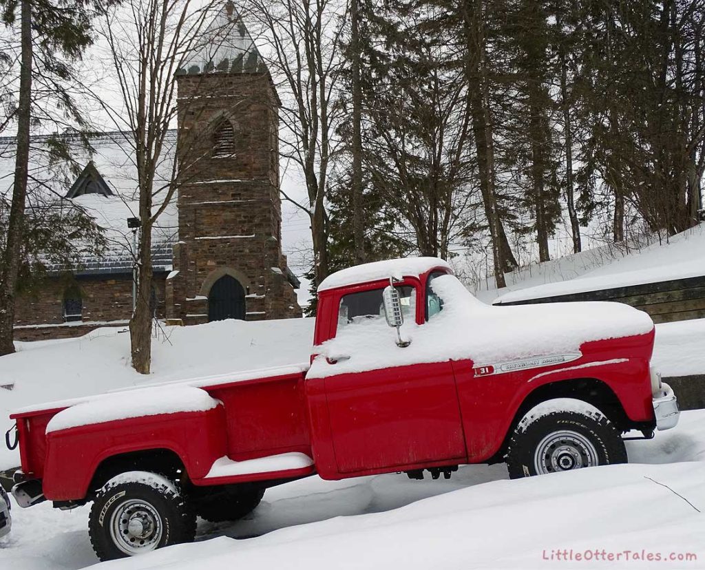 1959 red Chevy Apache pickup truck in snow
