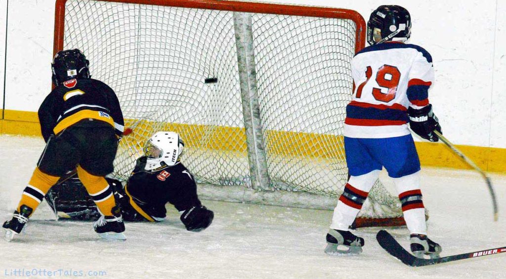 boys hockey game scoring goal
