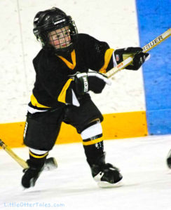 little boy playing ice hockey
